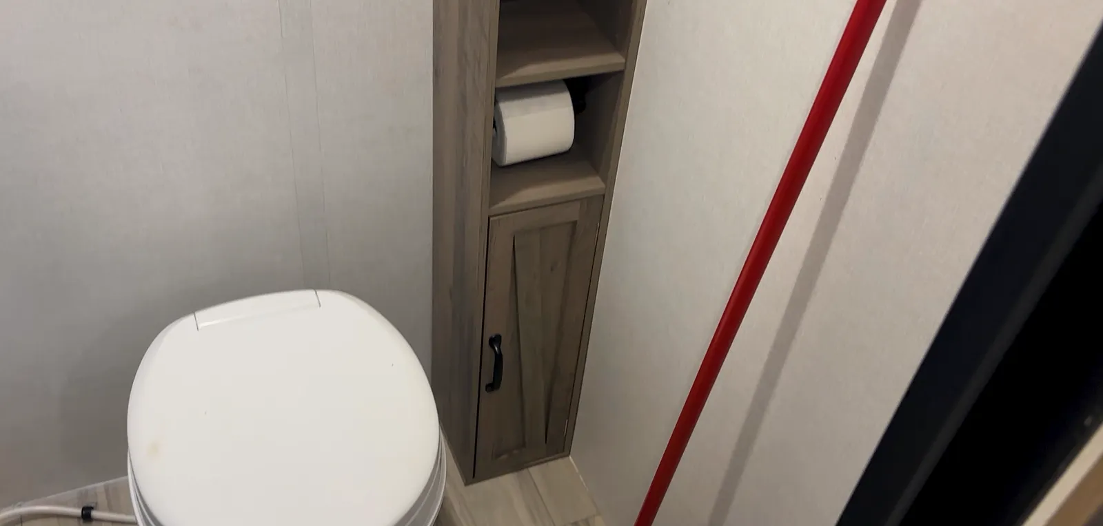 An aftermarket storage cabinet added in the Coleman 17B bathroom