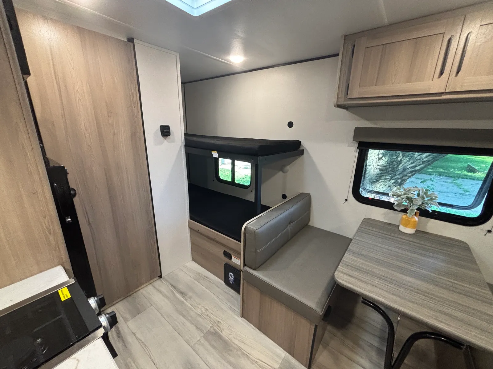 The booth dinette and bunk beds in the Coleman 17B