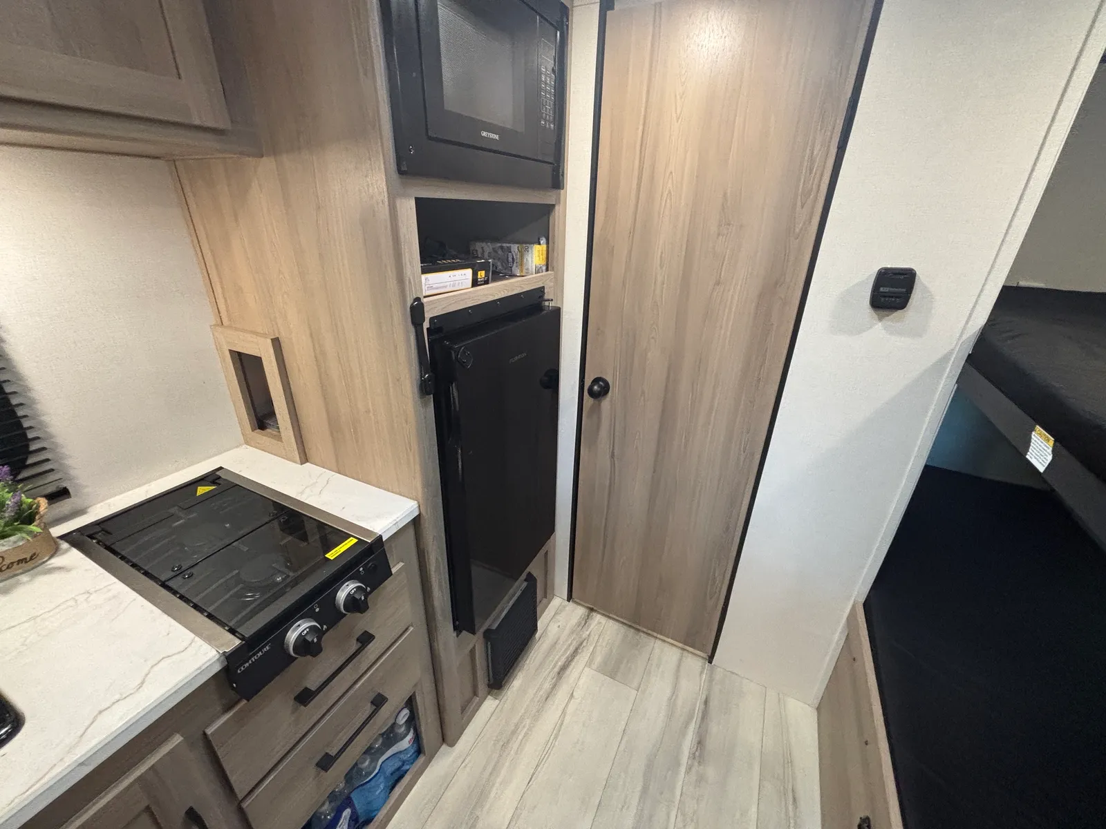 Cooktop, refrigerator, and hallway to the bunks