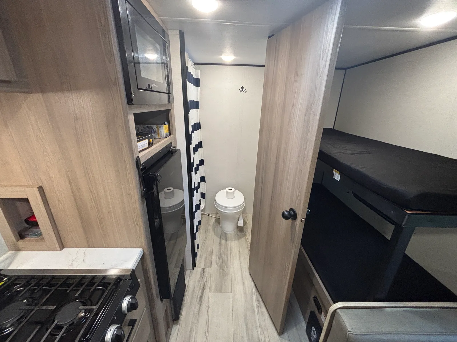 Hallway to the bathroom with the bunk beds alongside