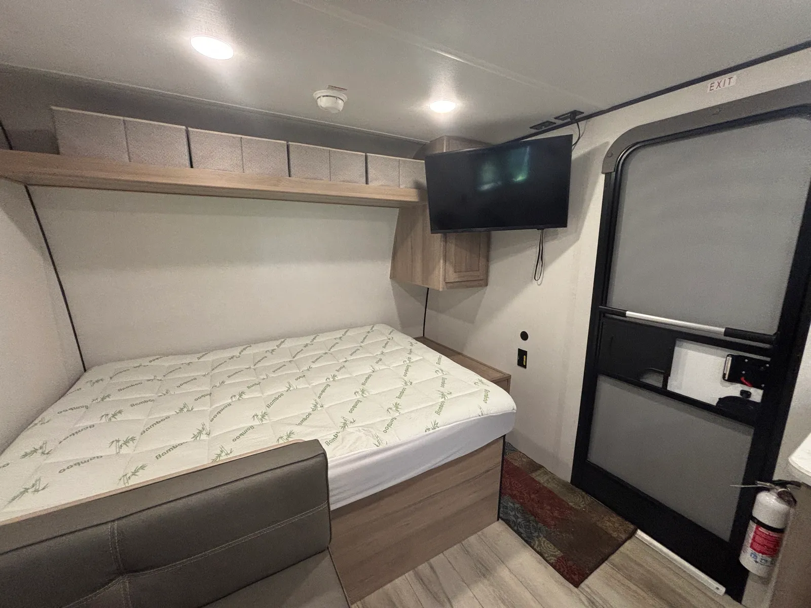 Queen bed with a wall-mounted TV