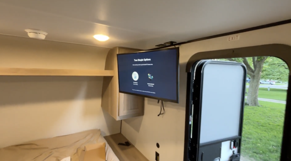 A 32 inch TV mounted on a swivel in a Coleman 17B
