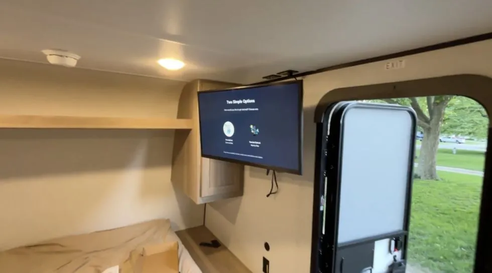 A 32 inch TV mounted on a swivel in a Coleman 17B