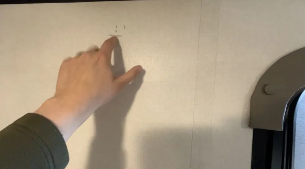 Checking the TV mount placement on the Coleman 17B wall